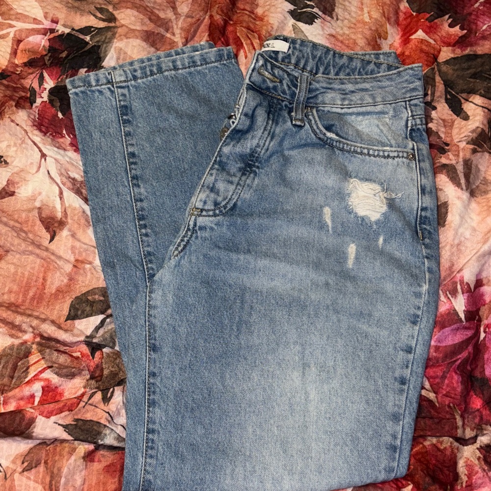 Womans Blue Distressed Jeans, five buttons. Size 27